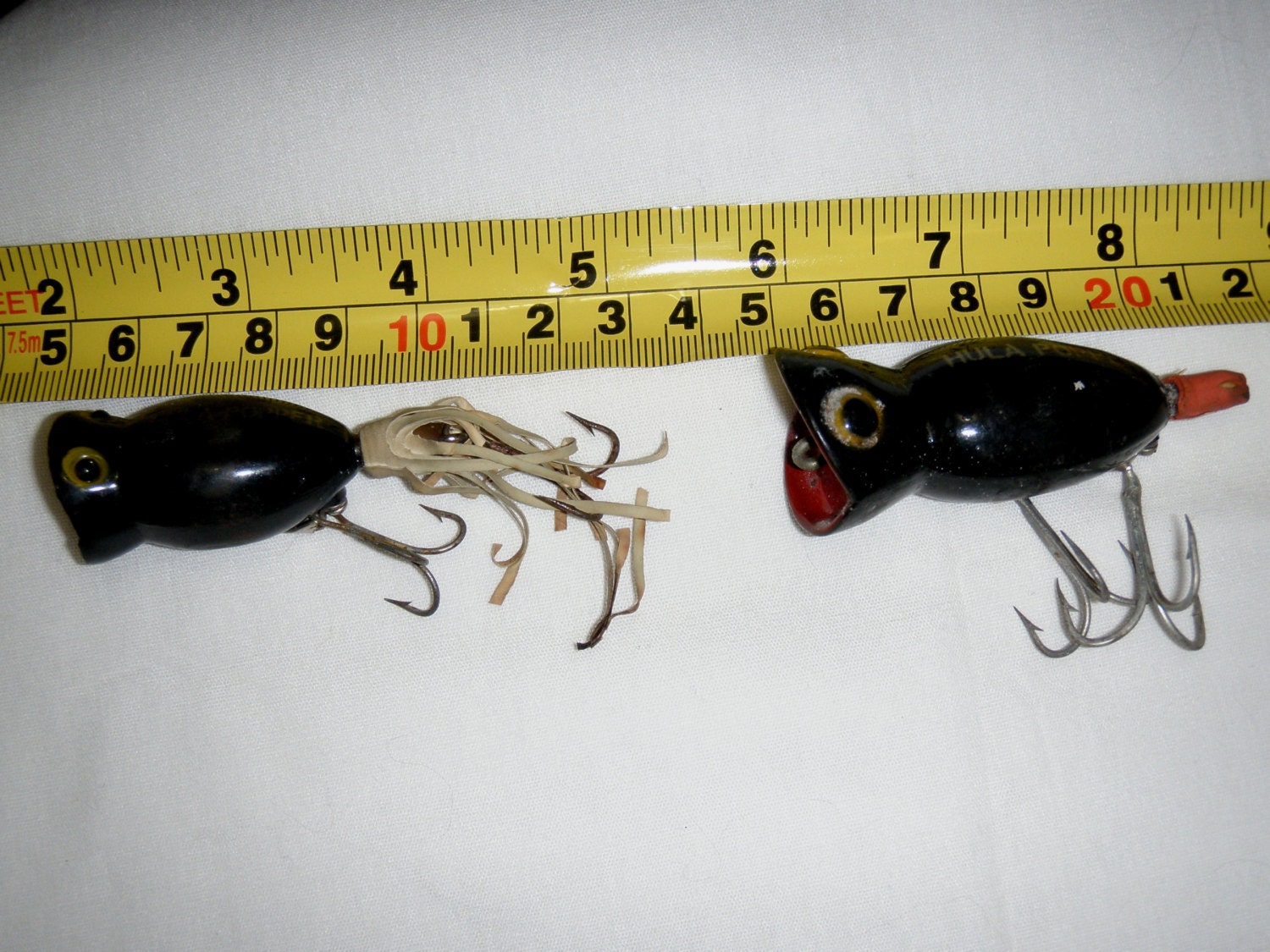 Two Vintage Hula Popper Fishing Lures in Different Sizes