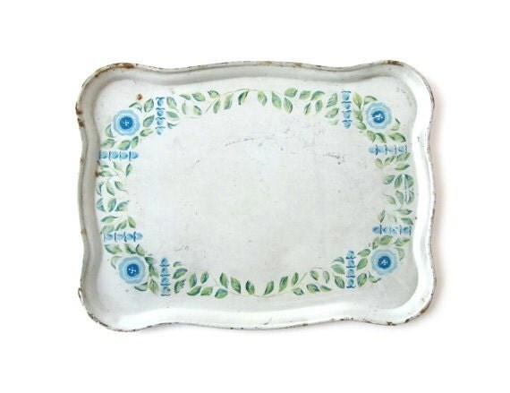 Vintage tin tray with blue floral theme. For a retro touch in your house, it is the cutest home decoration.