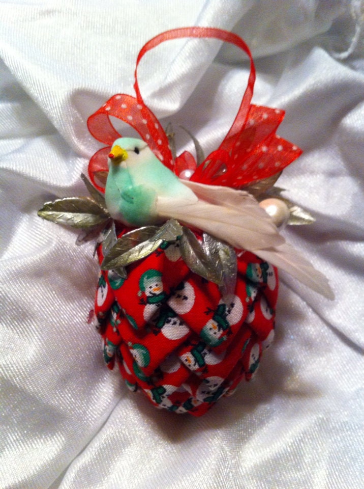 Red snowman print fabric pinecone decoration.
