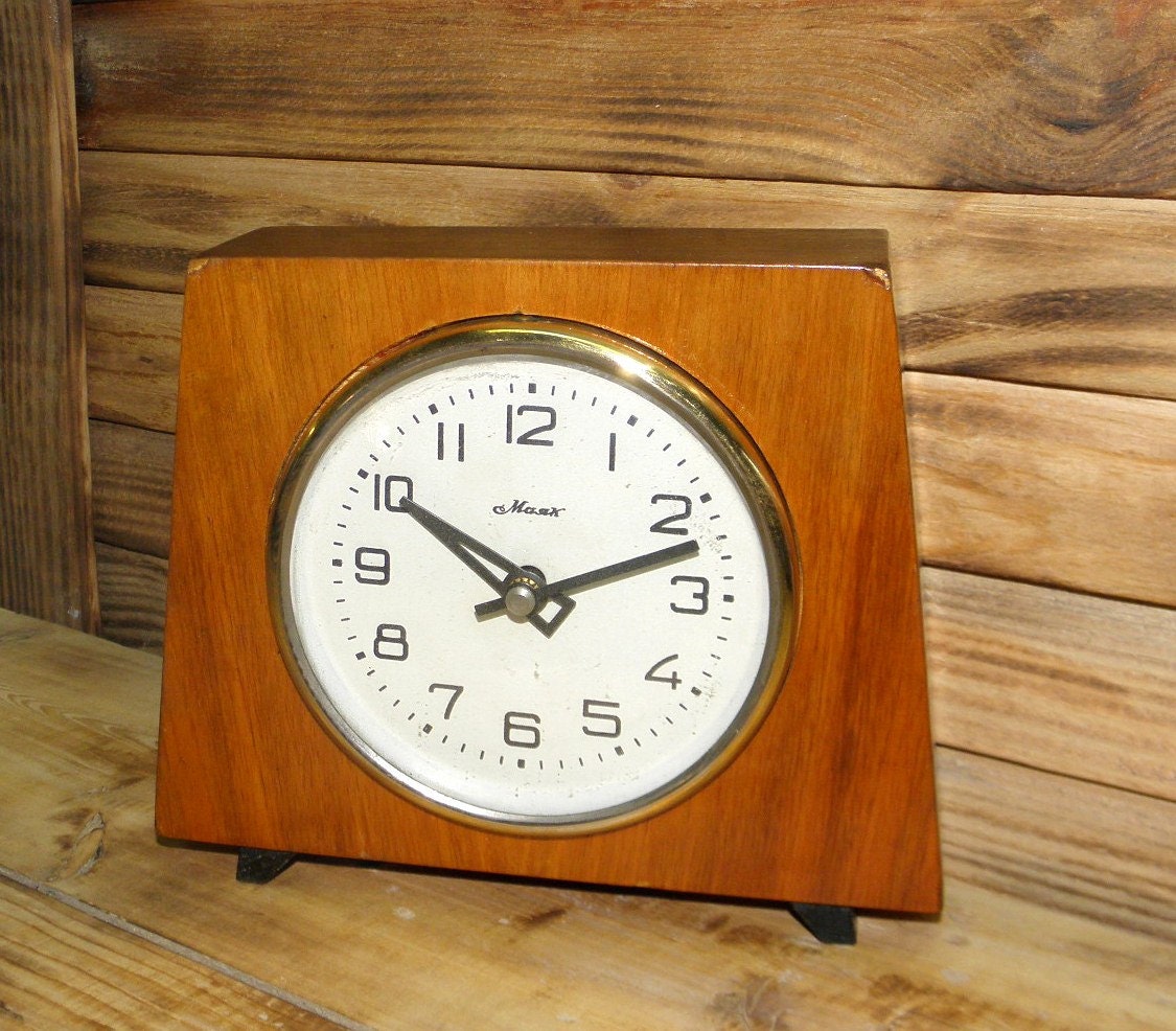Vintage wooden desktops clock with a brass rim. Mechanical