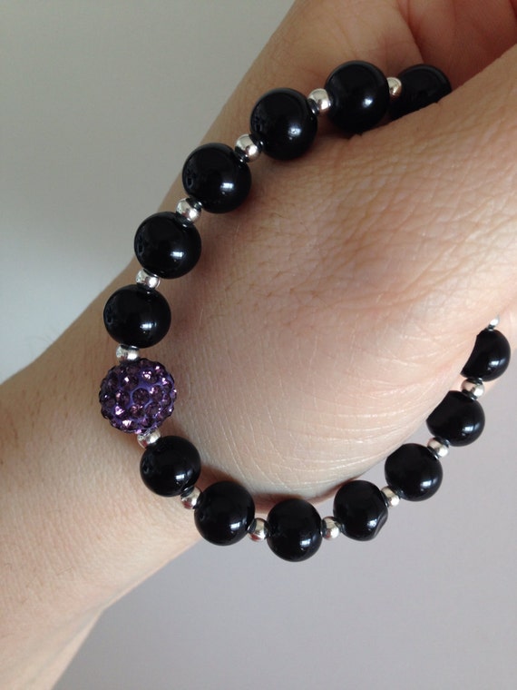 Items similar to Purple clay rhinestone and black bead bracelet on Etsy