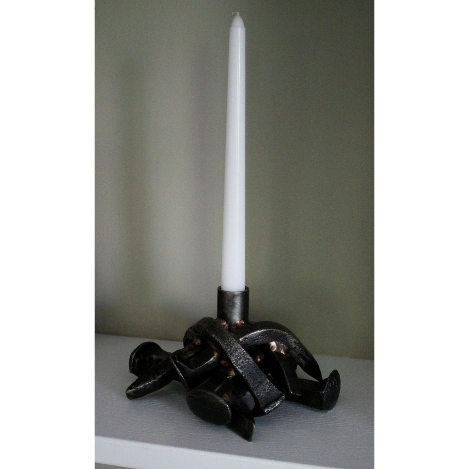 Candle holder made from reclaimed railroad spikes by