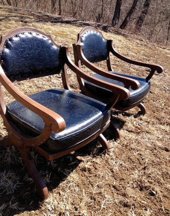 a Pair of Spanish Revival Mid Century Black Leather Chairs