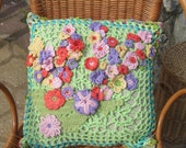 crochetted pillow over with bird and flowers