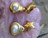 Golden Star Earrings Set In Goldtone With A Dangle Oval Pearl Accent