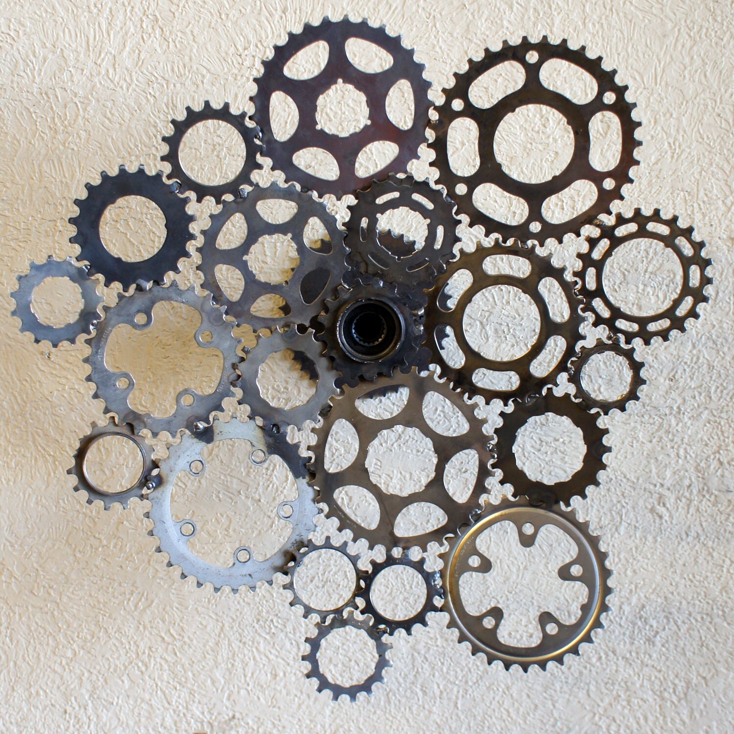 Recycled bicycle sprocket wall sculpture spins 360 degrees