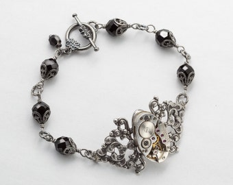 Steampunk Bracelet Vintage Waltham watch movement gears, silver filigree flower jet black crystal beaded bracelet by Steampunk Nation