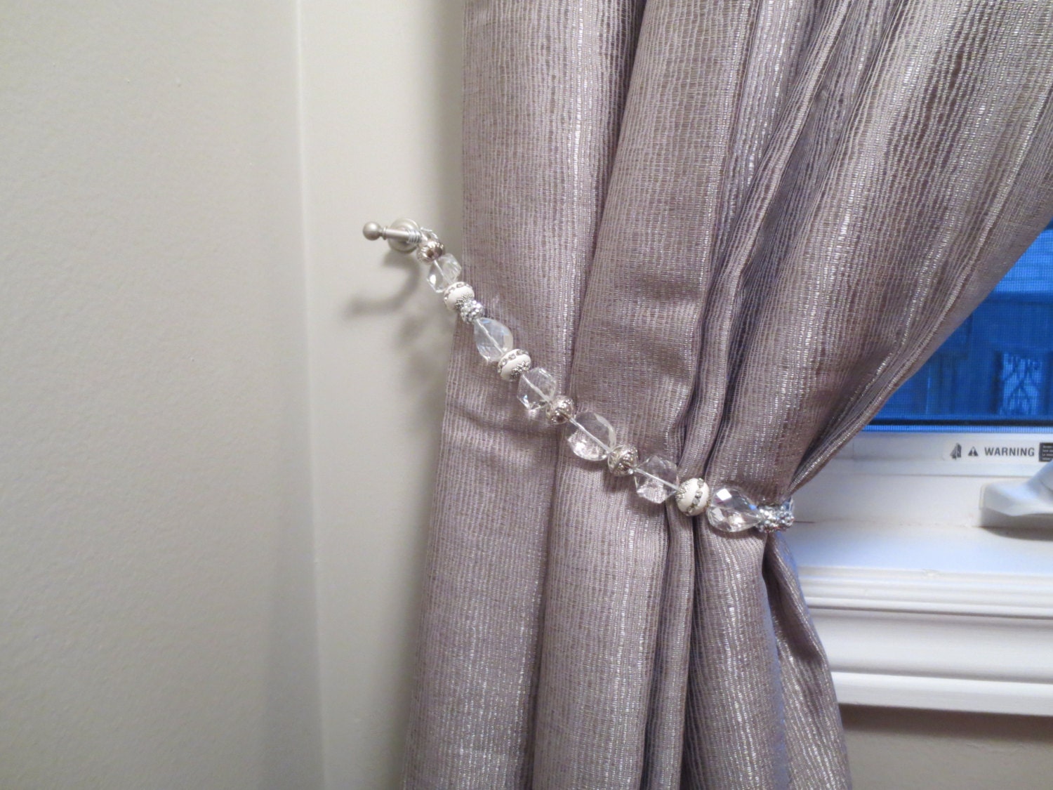 Beaded drapery tieback with clear silver & white beads with