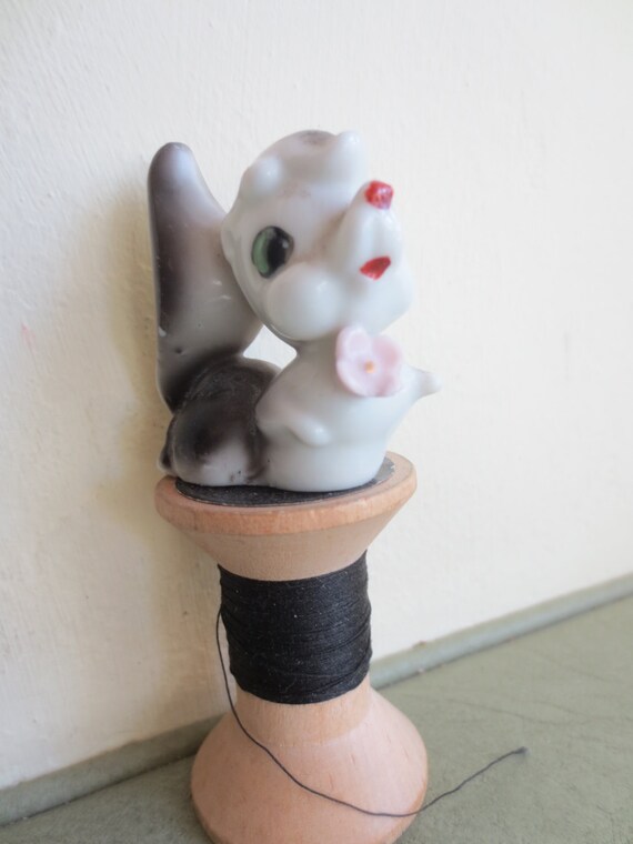 ceramic skunk figurines