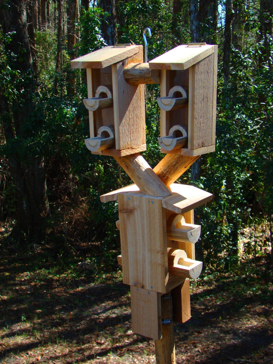 Outdoor bird house feeder looks like 3 wooden birdhouses but