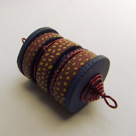 Kinetic cylinder bead pendant, wire wrapped polymer clay art bead, wine indigo yellow