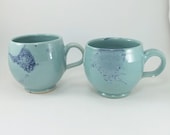 pair of awesome light green and blue mugs