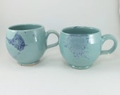 pair of awesome light green and blue mugs