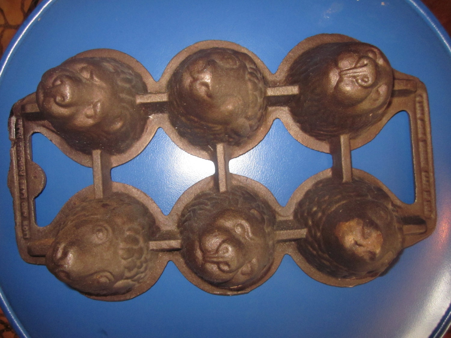 cast iron popover pan. lamb and lion heads