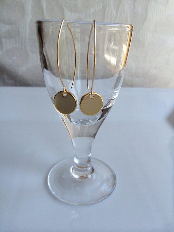 Items similar to Shiny gold dangle earring on Etsy