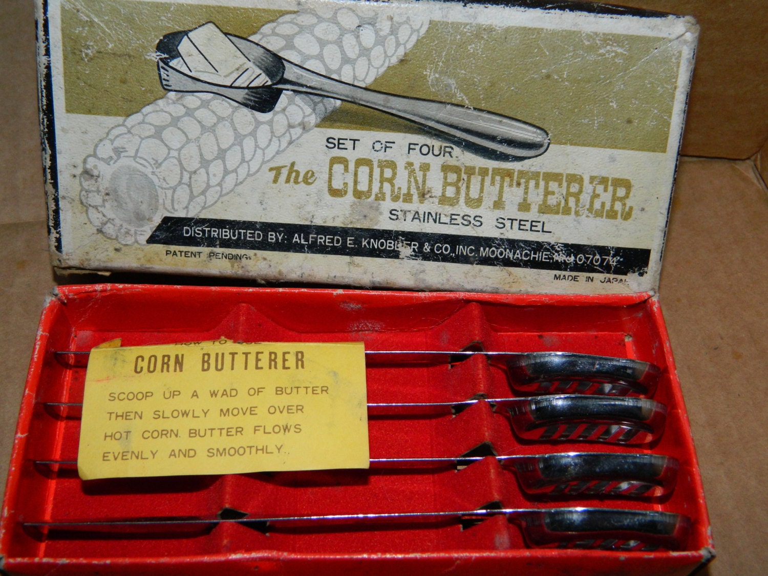 Set of four stainless steel corn butterer utensils in the original box