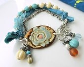 BACK2SCHOOL SALE!  Pale blue, cream, and burnt orange bracelet w/ pottery cuff bead, sari silk, and silver ox chain