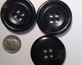 3 large black buttons. 1 1/4 inches.