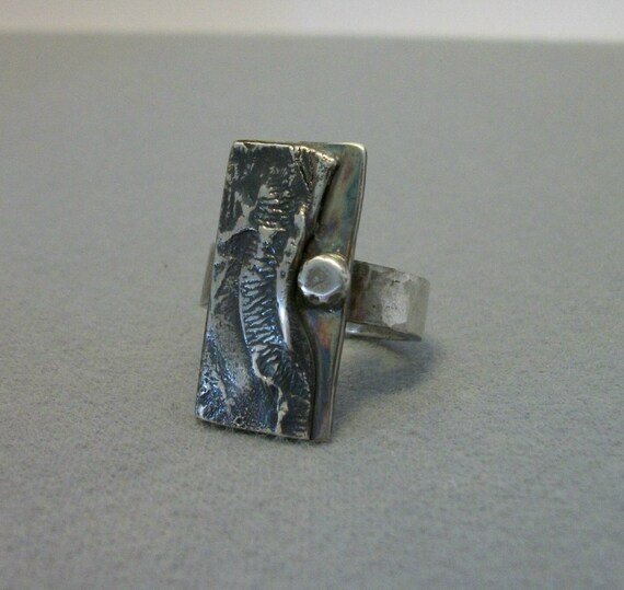 Hand forged sterling silver ring with reticulated silver