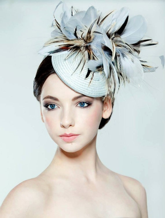 Light blue straw percher hat with feather trim perfect for weddings or races.