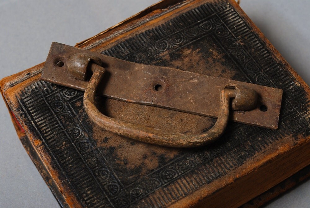 Antique brass escutcheon with pull handle