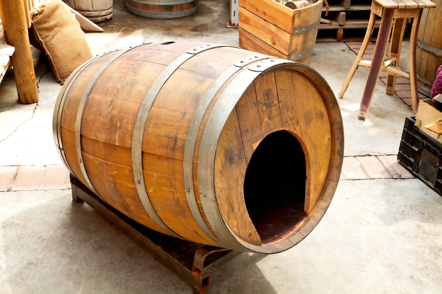 Rustic pet house made from a wine or whiskey barrel. Sits on a
