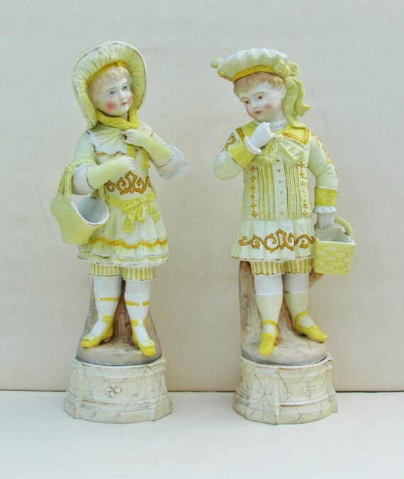 Pair of antique bisque figurines Victorian boy and girl with