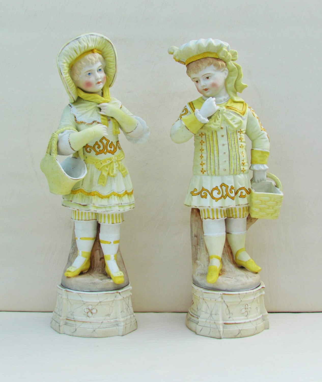 Pair of antique bisque figurines Victorian boy and girl with
