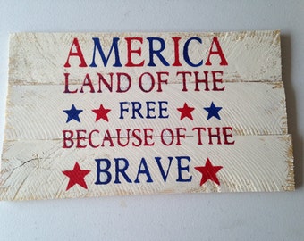 sign that reads land of the free because of the brave