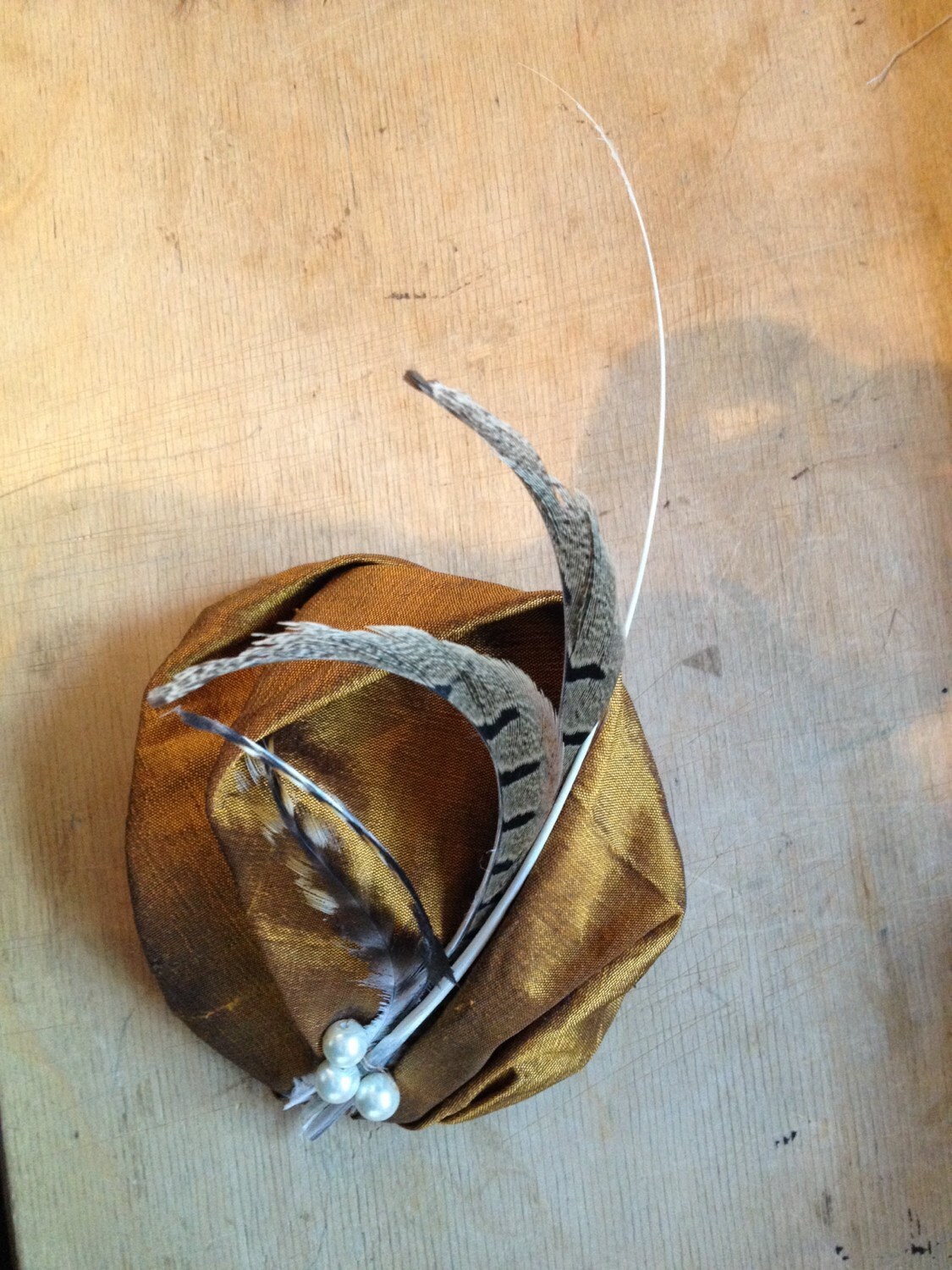 Gold feather fascinator with pearl detail