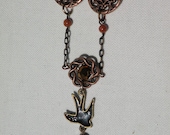 Black and Brass falling bird with medallions necklace