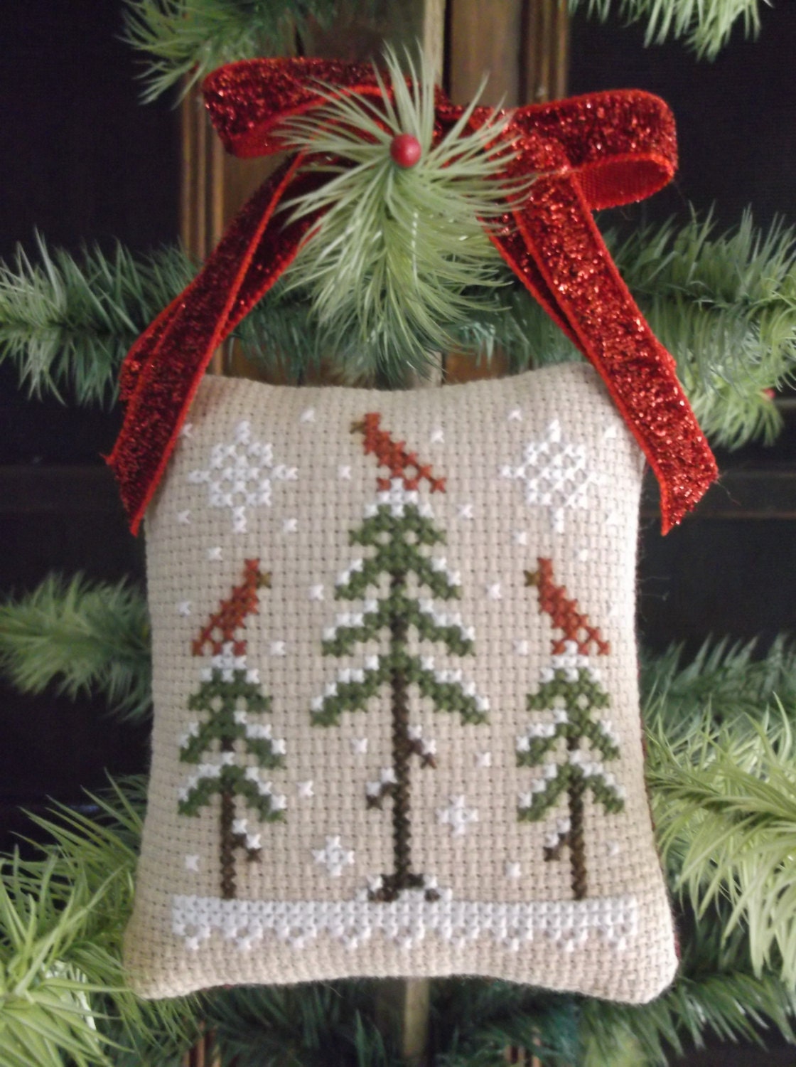 Completed Cross Stitch winter scene with cardinals pinkeep