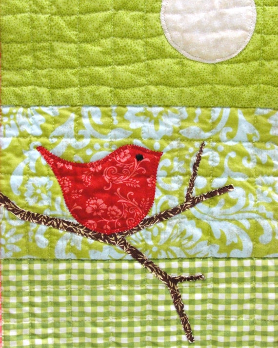 red bird mini wall quilt- red bird on bare branch against a background of green for Christmas and winter