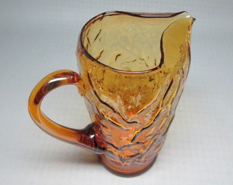 morgantown seneca driftwood / crinkle glass pitcher in an amber color