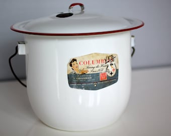 White vintage enamelware cook pot rimmed in red with lid and handle