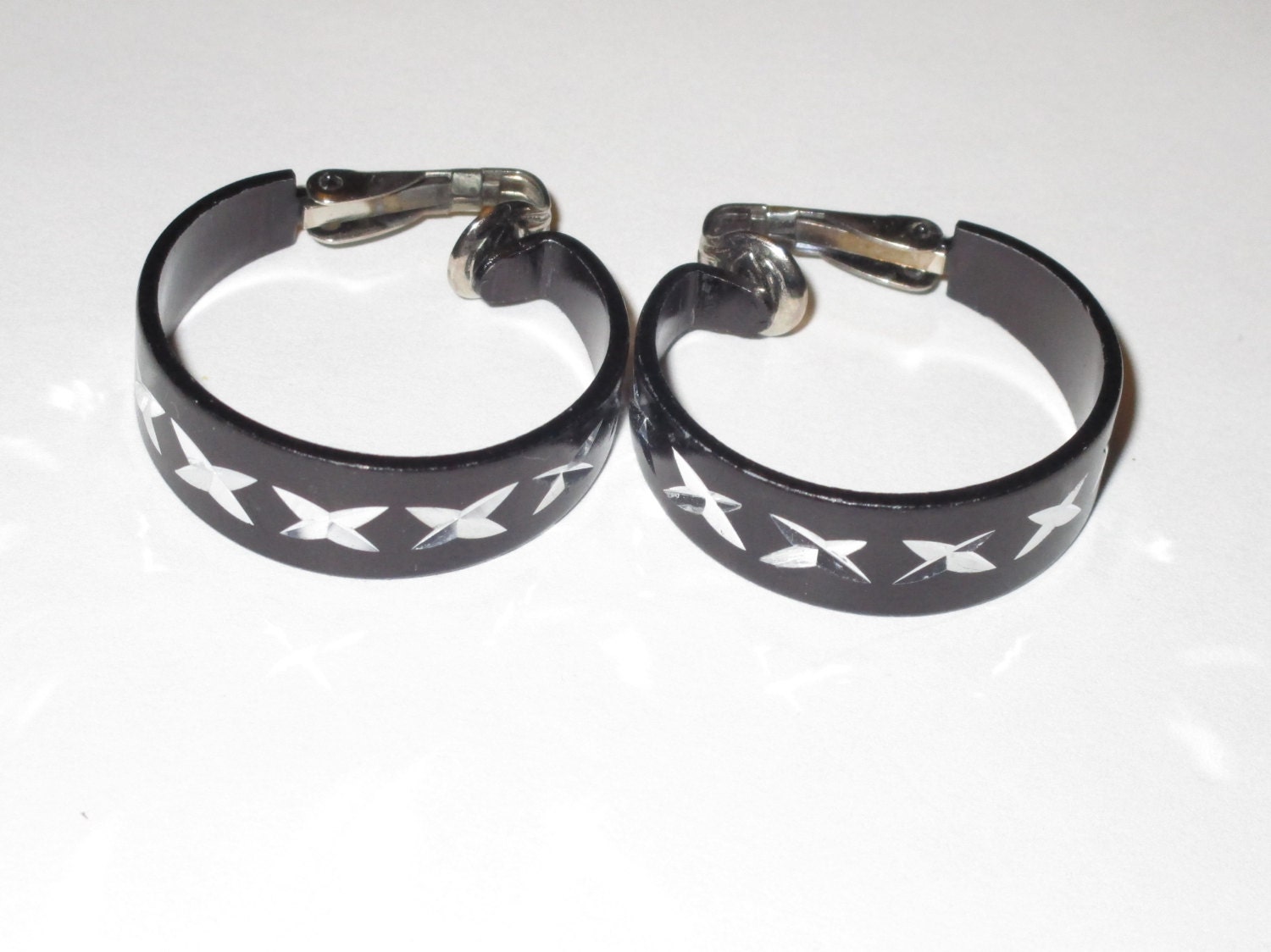 Black clip on earrings marked Hong Kong epsteam