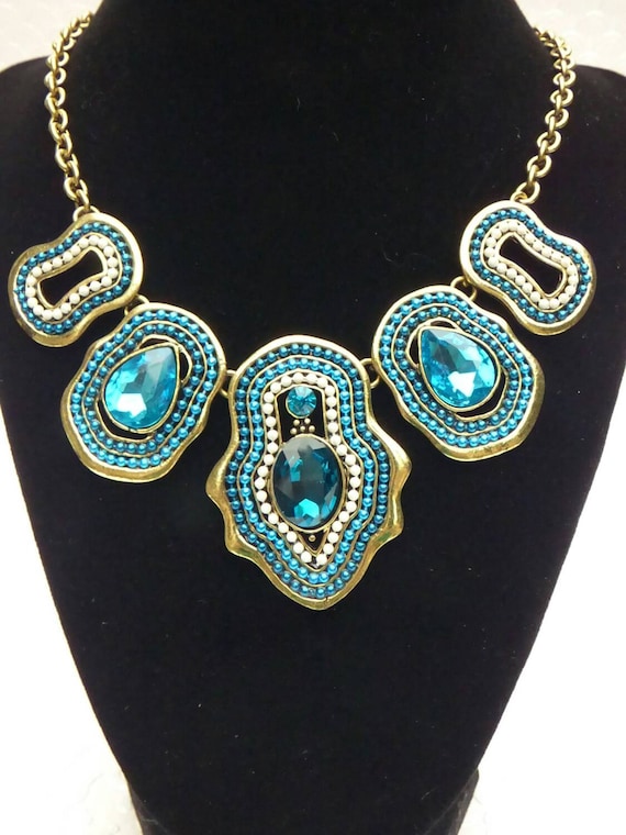 Brilliant Blue and Brass Colored Metal Statement Necklace with White Accents