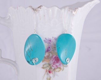 Elegant long sterling silver earrings with beautiful twisted oval blue howlite turquoise stones, sterling silver spirals, marquis hooks