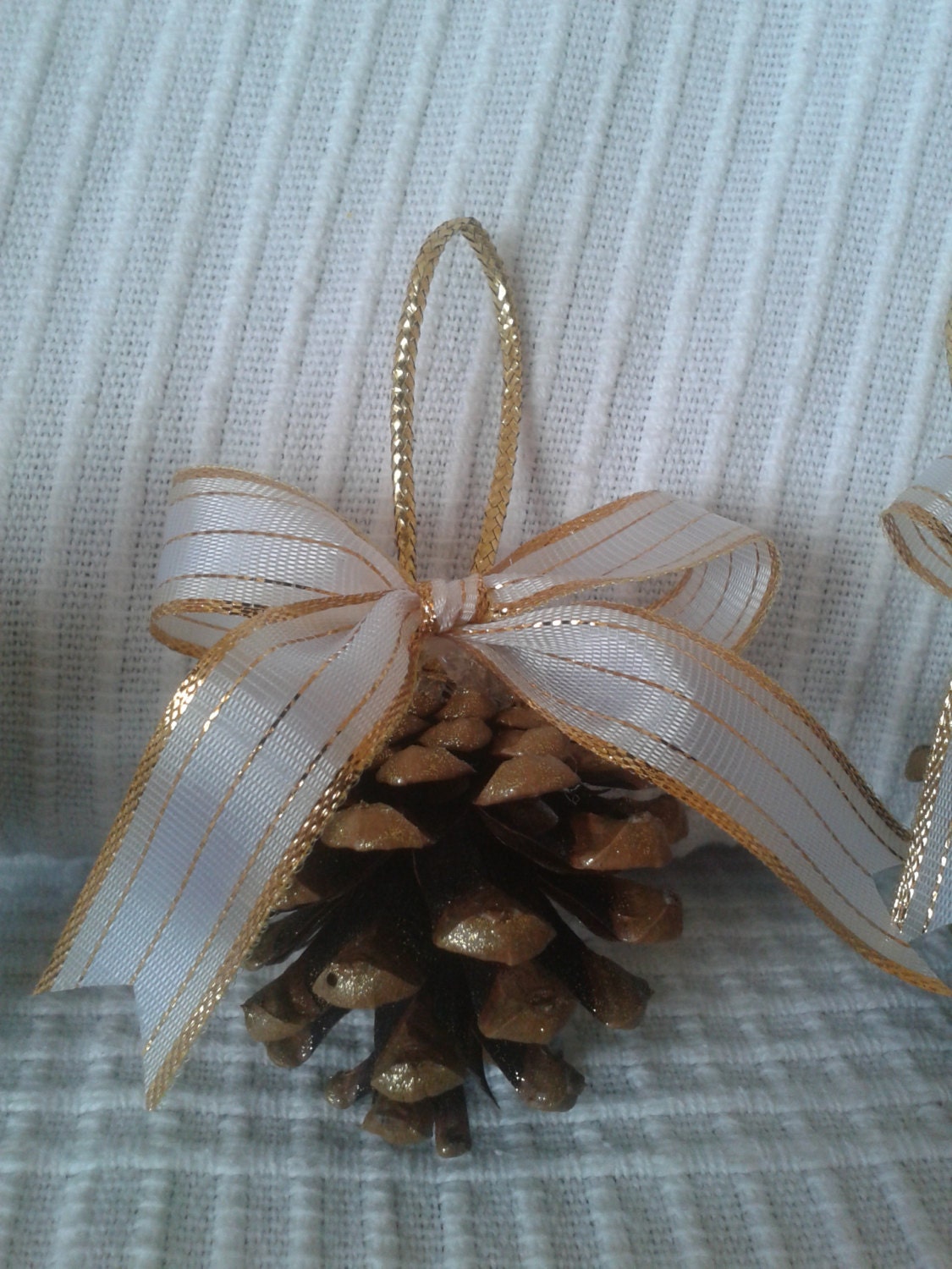 Set of three handmade golden pinecones Christmas ornaments with a bow for your Christmas tree