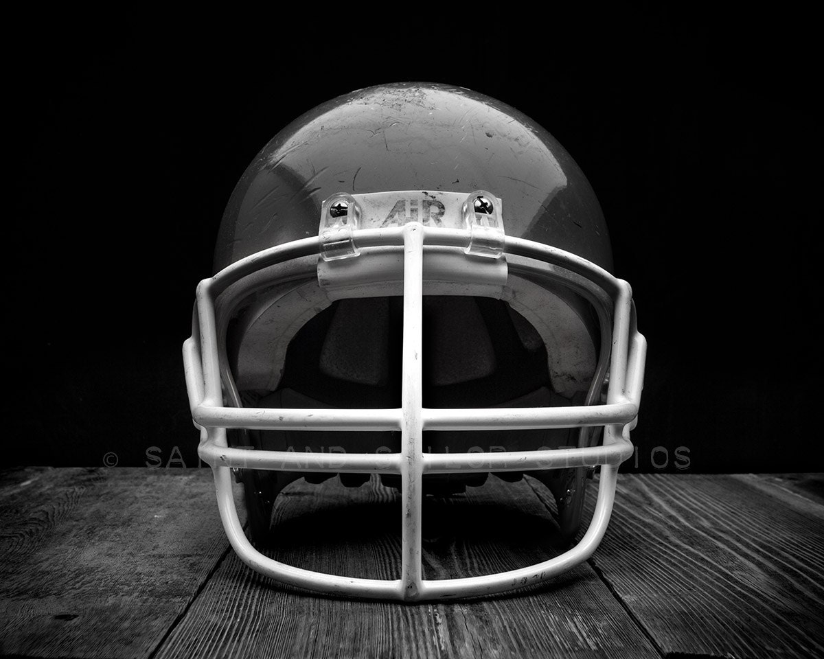 Vintage Black Football Helmet Facing on Classic Black Photo