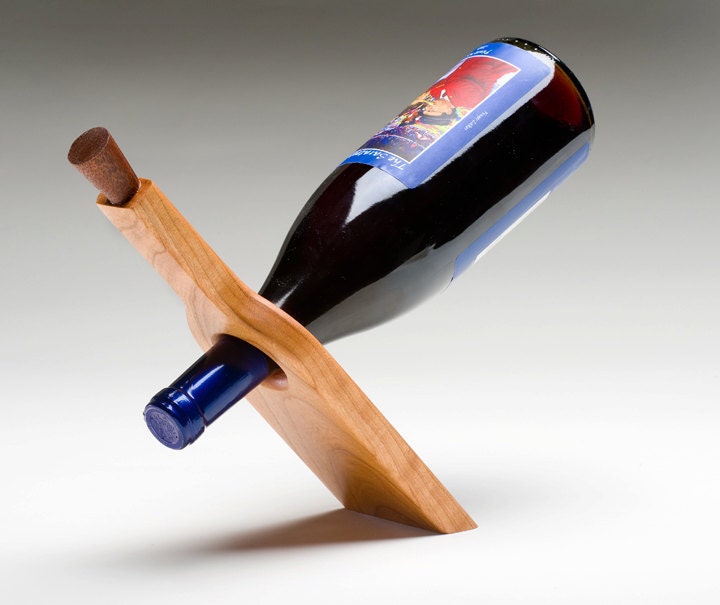 Handmade wooden wine stand perfectly balances full wine