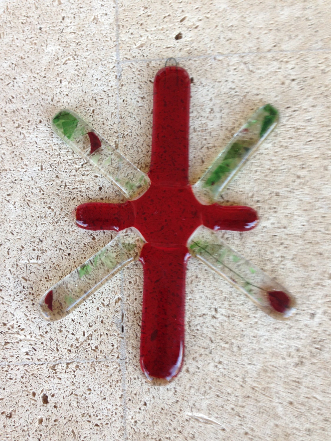 Handmade fused glass red cross can be used as an ornament for a Christmas tree or a suncatcher