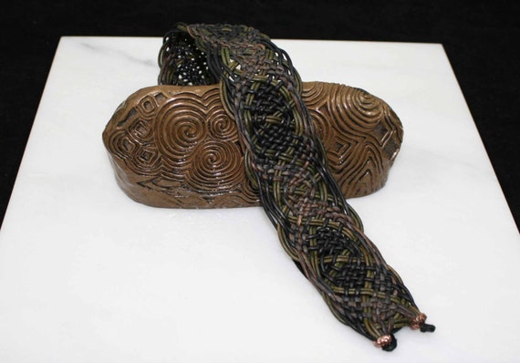 Handmade Celtic leatherwork in gray, green, and black