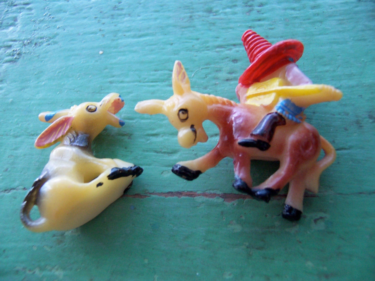 two happy plastic donkey figurines