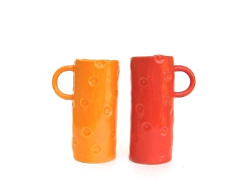 two festive hand built porcelain ... red and orange tall dot cups ... cup