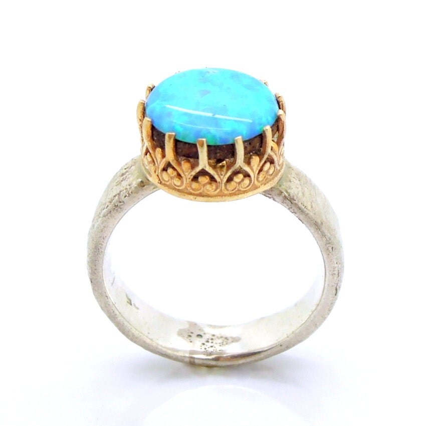 Opal ring set in a gold lace and sterling silver hammered band