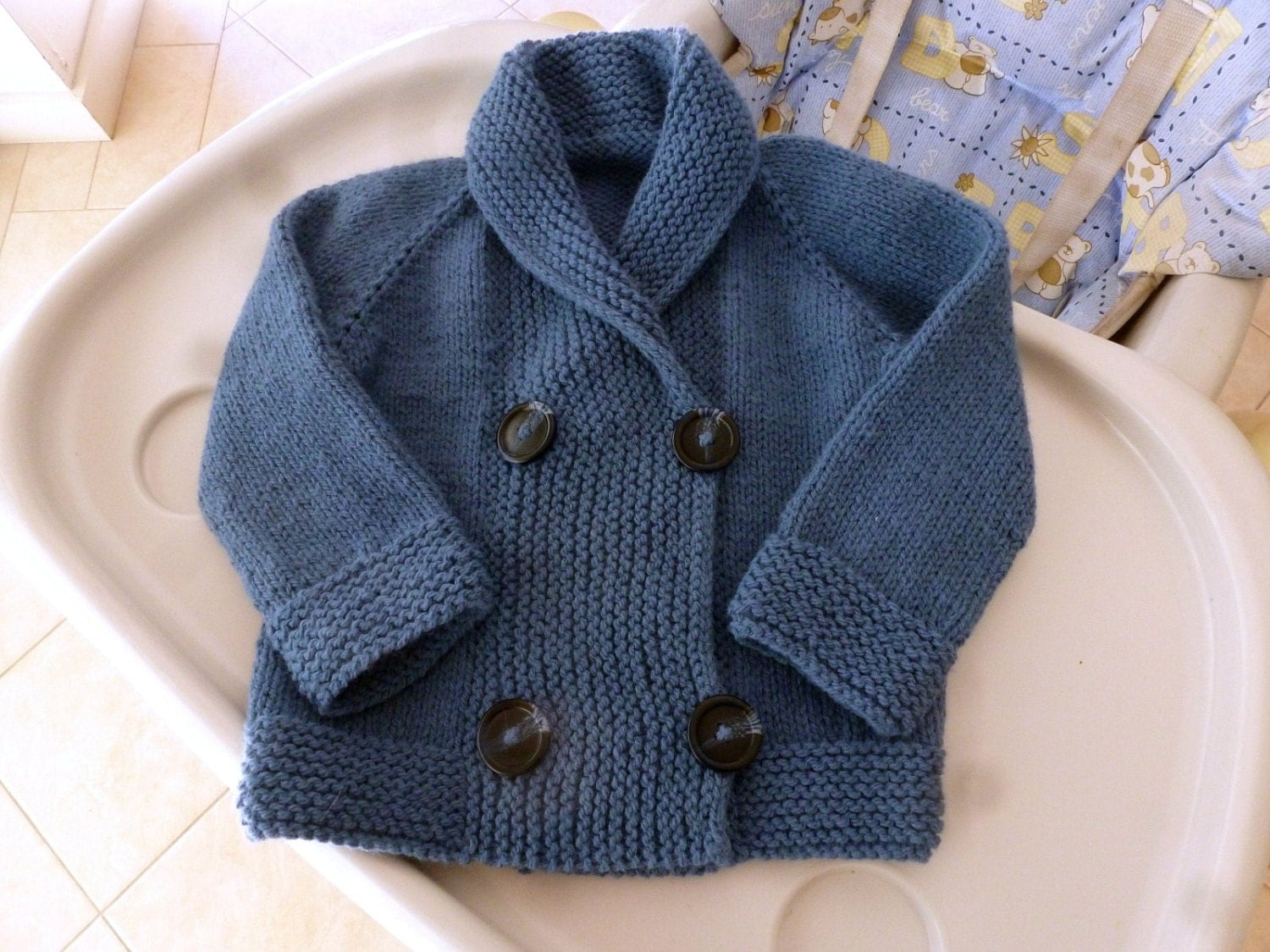 Hand knitted double breasted baby jacket shawl by SnuggleBubs