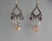 Purple beaded dangle earrings with a diamond center