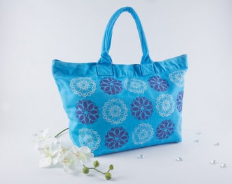 Turquoise canvas deck, travel, beach, book bag, hand dyed and screen printed with ellipse flower pattern in dark purple and white