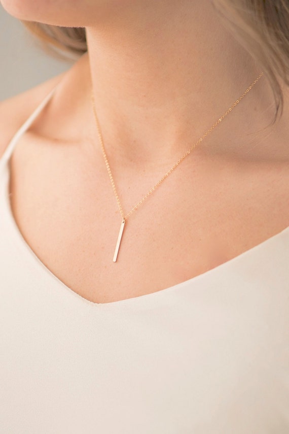 Vertical, smooth gold bar necklace (model photo)